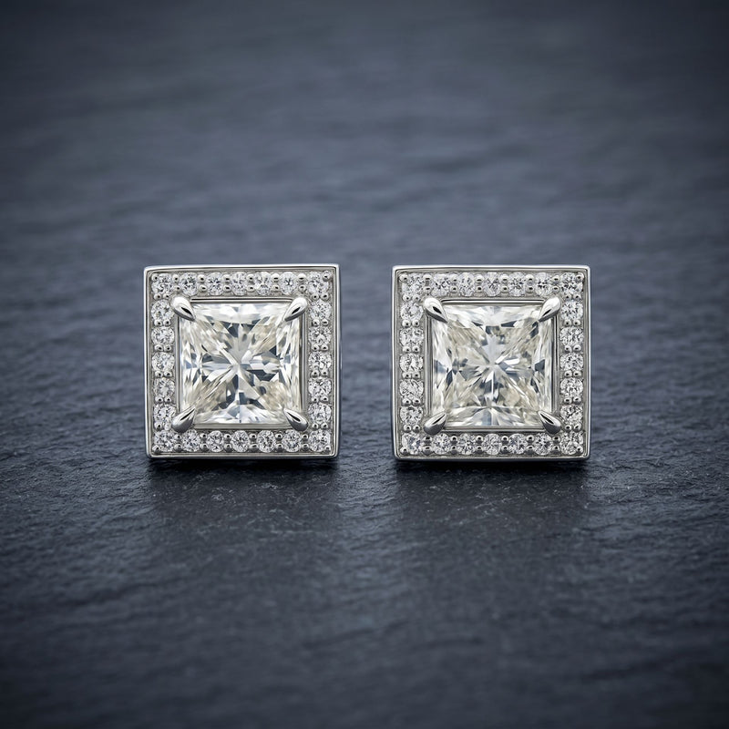 Square lab grown diamond stud earrings on a dark textured background
