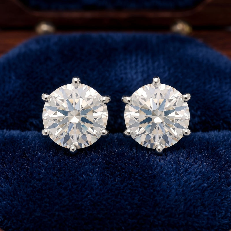 Lab Grown Diamond Stud Earrings on a blue fabric.