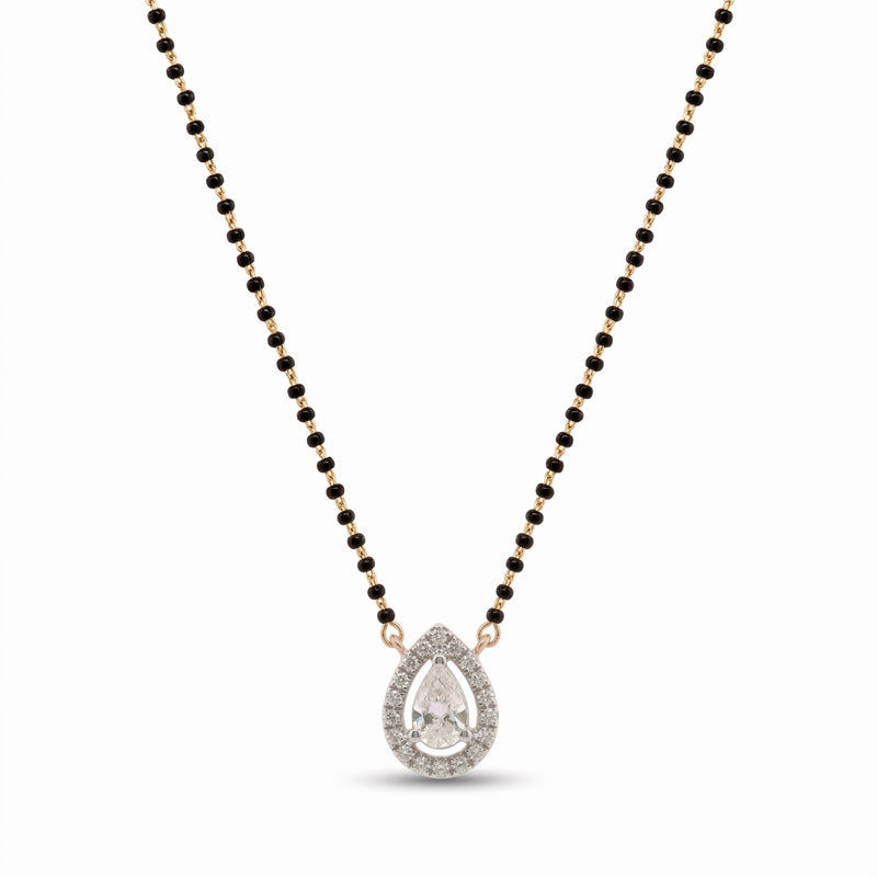 A teardrop-shaped pendant necklace featuring a clear pear-cut center stone surrounded by small clear stones, suspended on a black beaded chain with rose gold-toned accents, shown on a plain white background.