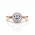 Rose gold ring with a large diamond on a white background