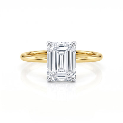 Gold ring with a large diamond on a white background