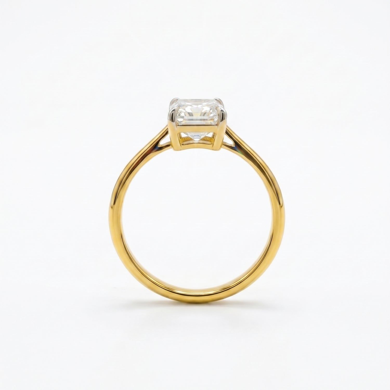 Gold ring with a diamond on a white background