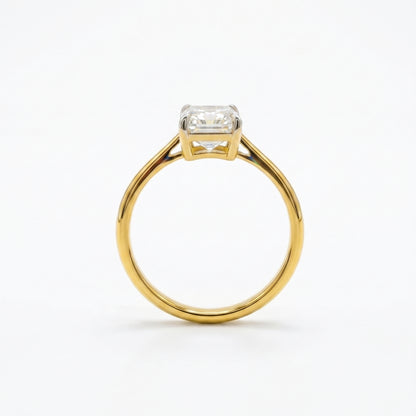 Gold ring with a diamond on a white background