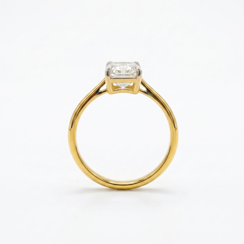 Gold ring with a diamond on a white background