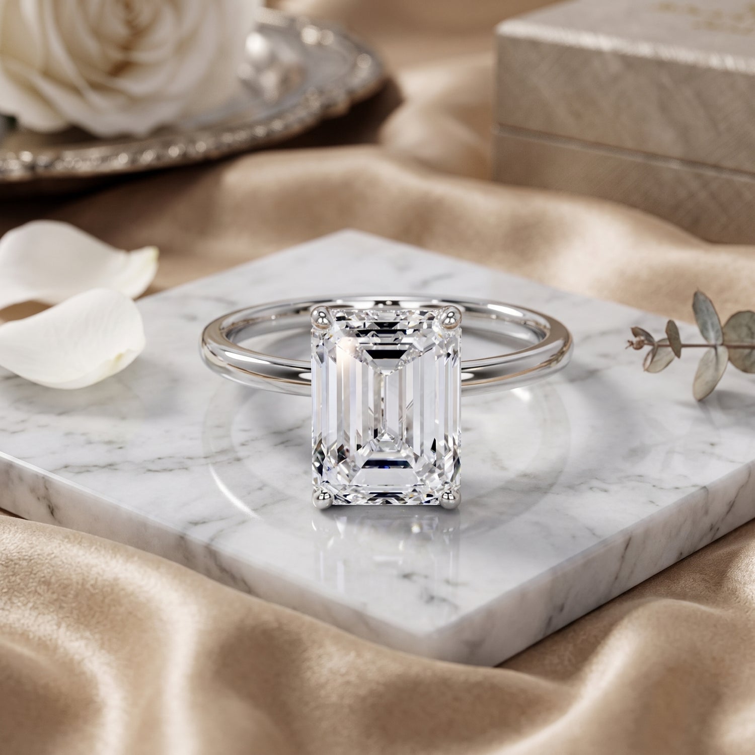 Diamond ring on a marble surface with flowers and jewelry box in the background
