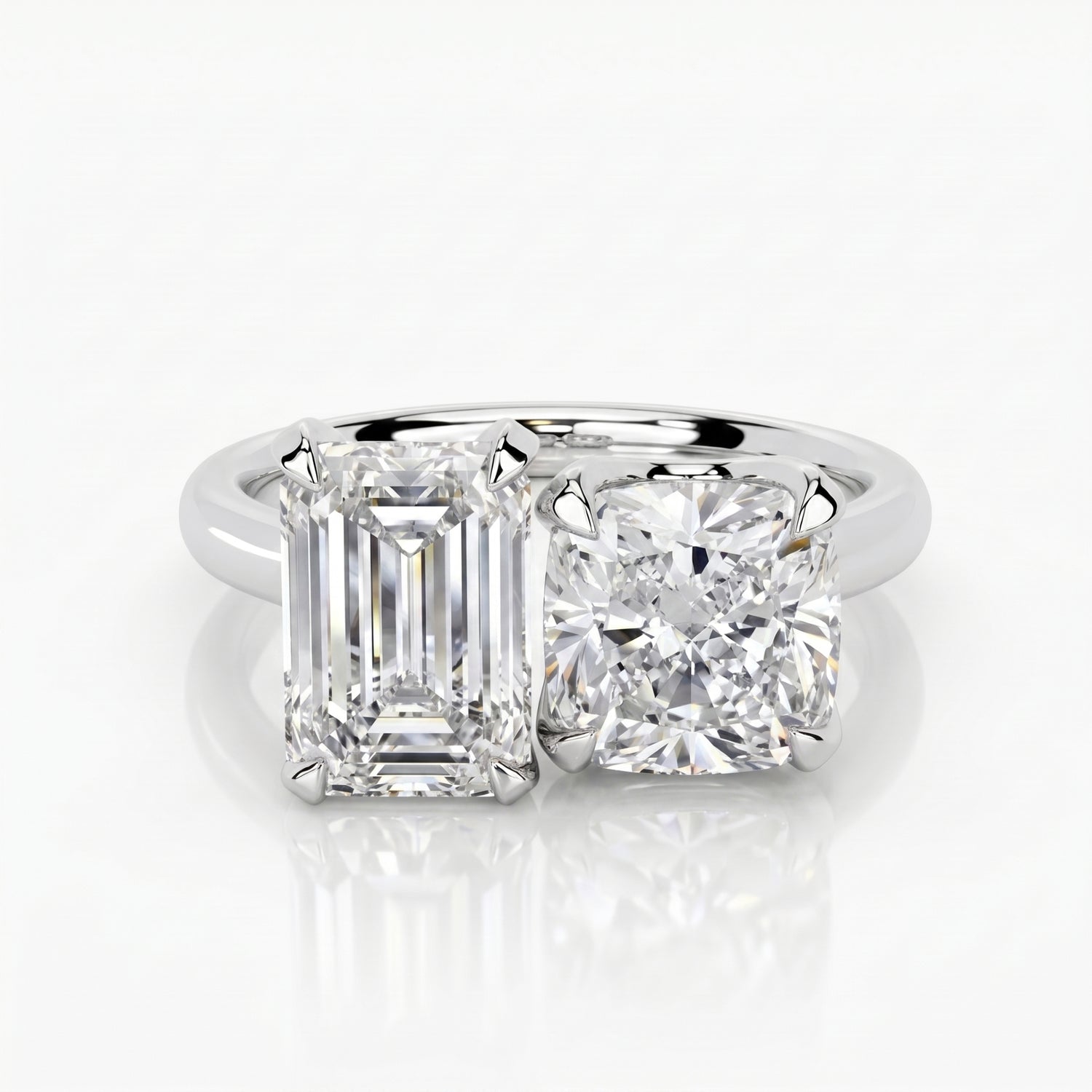 Diamond ring with emerald-cut and round diamonds on a white background