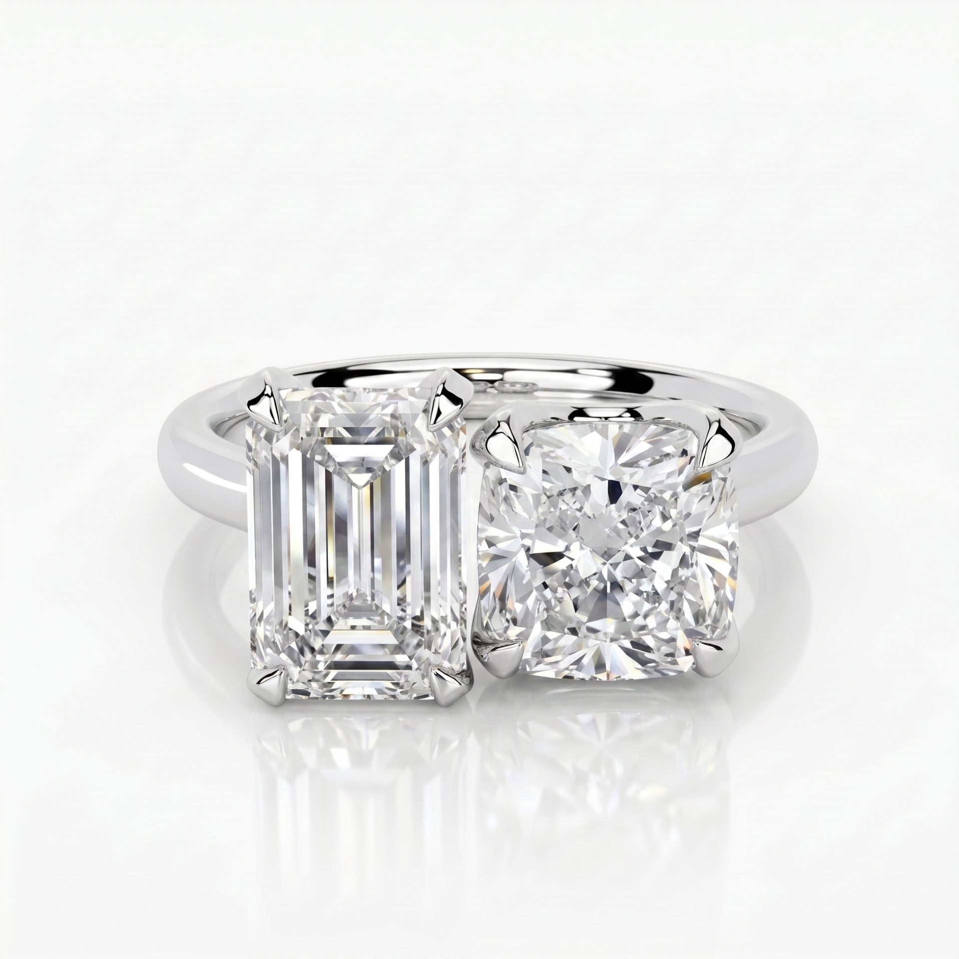 Diamond ring with emerald-cut and round diamonds on a white background