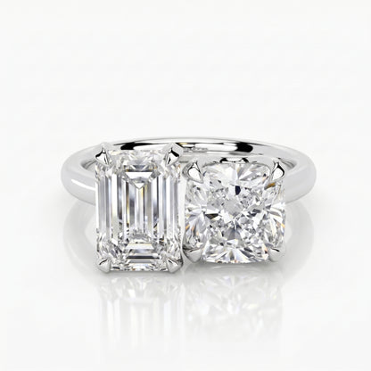 Diamond ring with emerald-cut and round diamonds on a white background