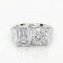 Diamond ring with emerald-cut and round diamonds on a white background