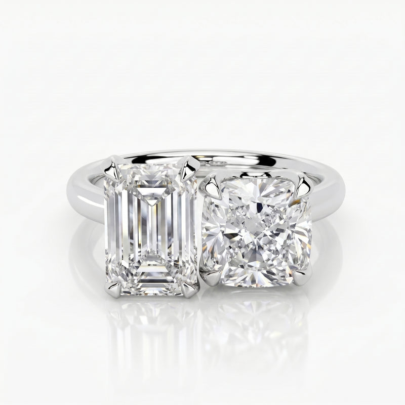 Diamond ring with emerald-cut and round diamonds on a white background