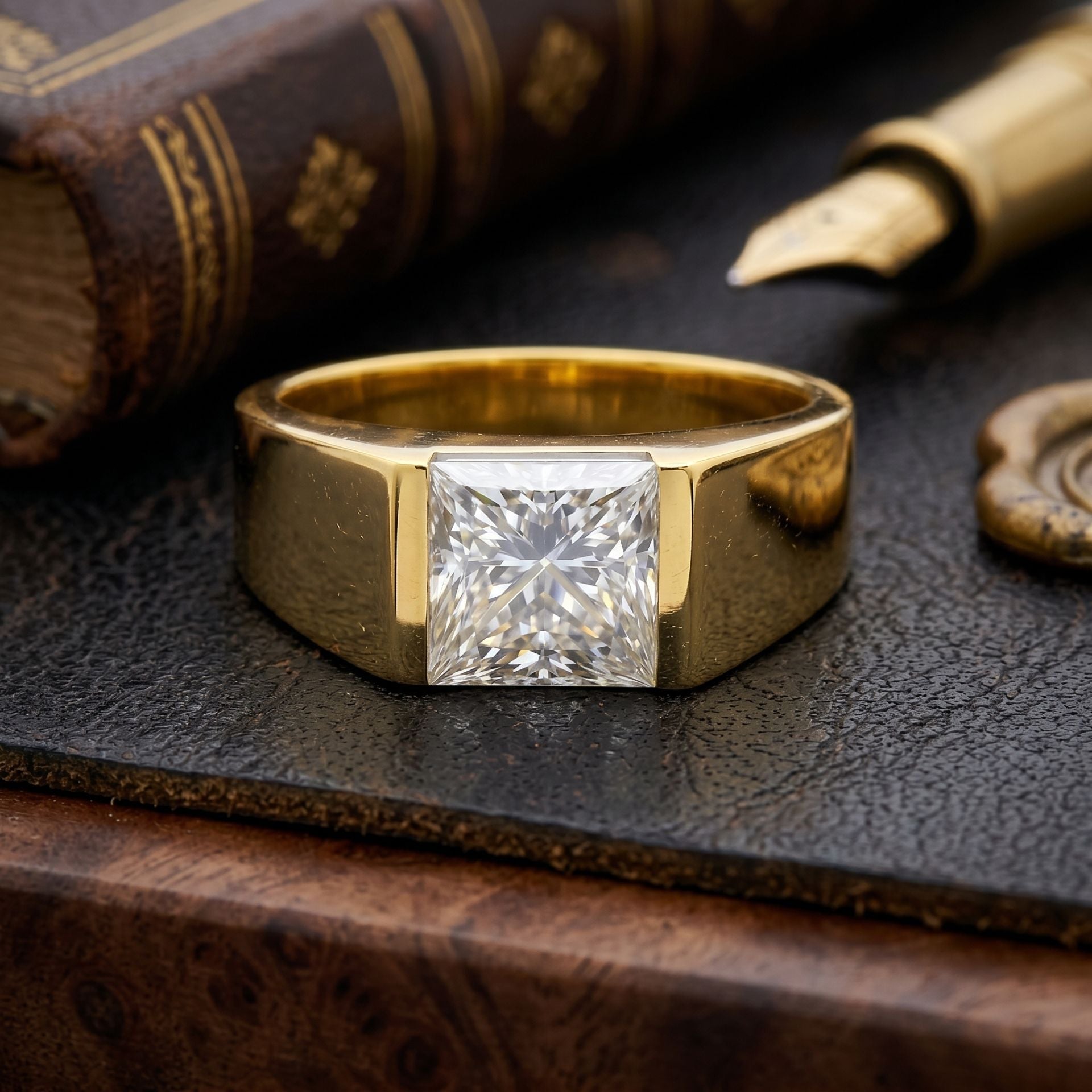 Gold ring with a diamond on a textured surface with an old book and quill pen.
