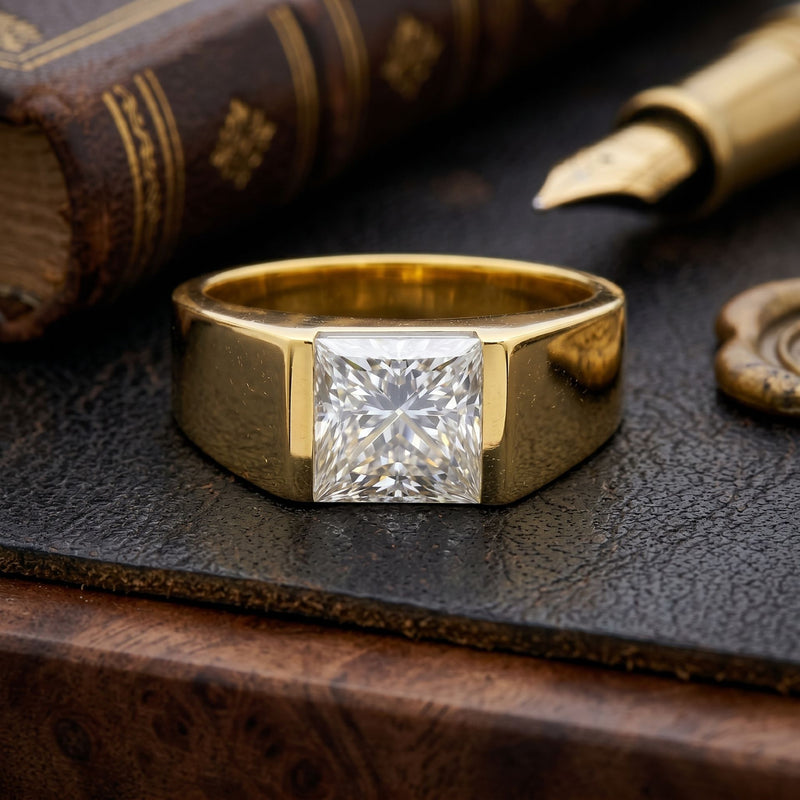 Gold ring with a diamond on a textured surface with an old book and quill pen.