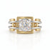 Two-tone gold and silver ring with a diamond on a white background