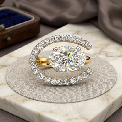 Gold ring with a large diamond on a marble surface
