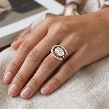 Close-up of a hand wearing a diamond ring on a neutral background