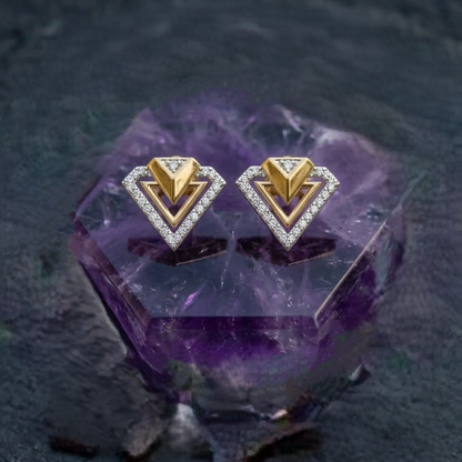 Gold and diamond earrings on a purple crystal