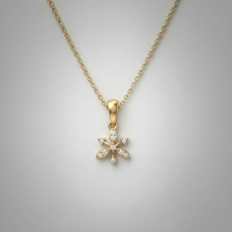 Gold necklace with a snowflake pendant on a gray background