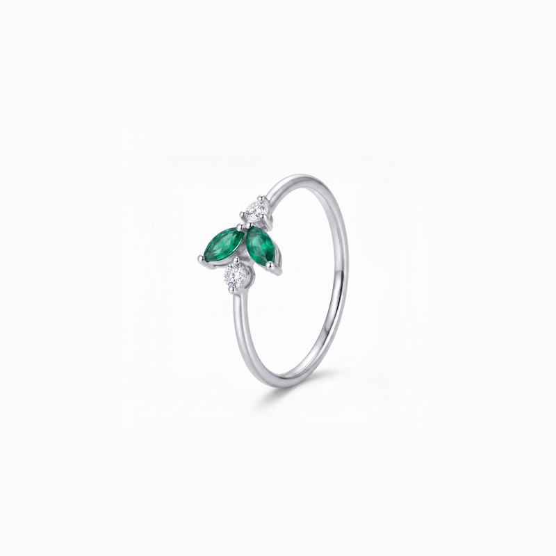 A silver ring featuring a butterfly design with two green marquise-cut stones and small clear accent stones, shown on a clean white background.