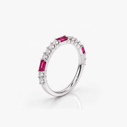 A silver band ring featuring baguette-cut pink gemstones and small round clear stones, shown on a light gray background with a soft reflection.