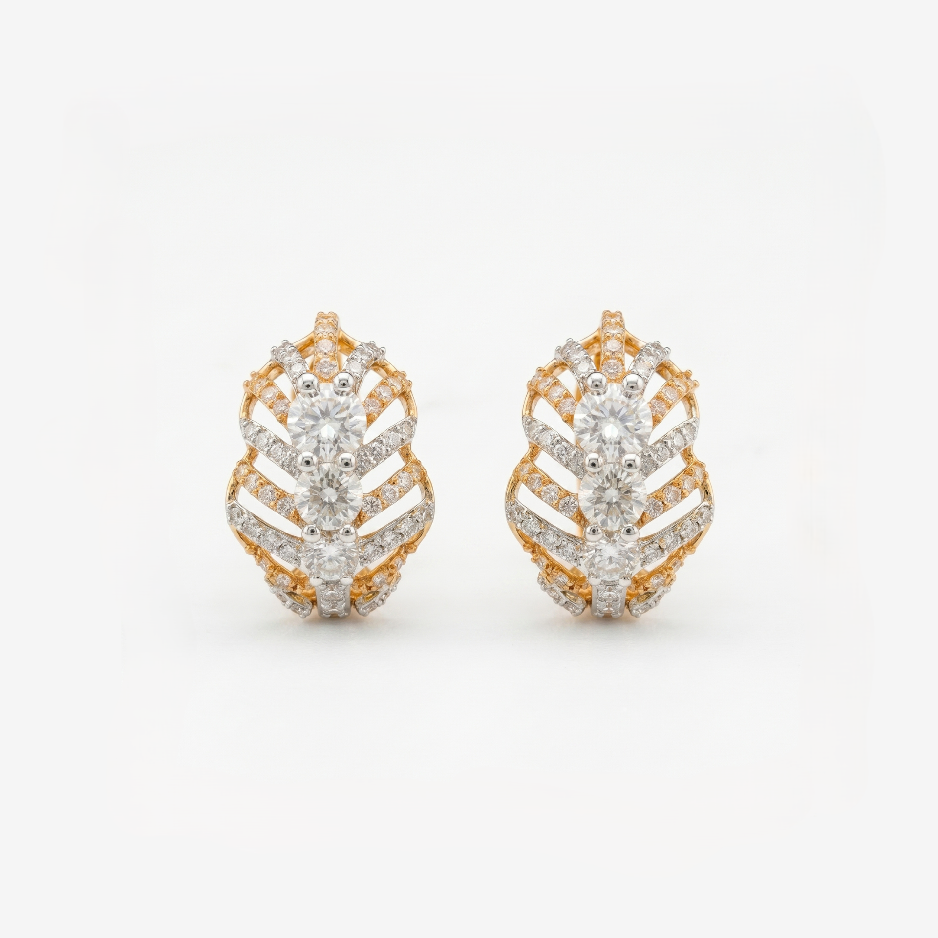Geometric gold stud earrings featuring sparkling lab-grown diamonds on a white background.