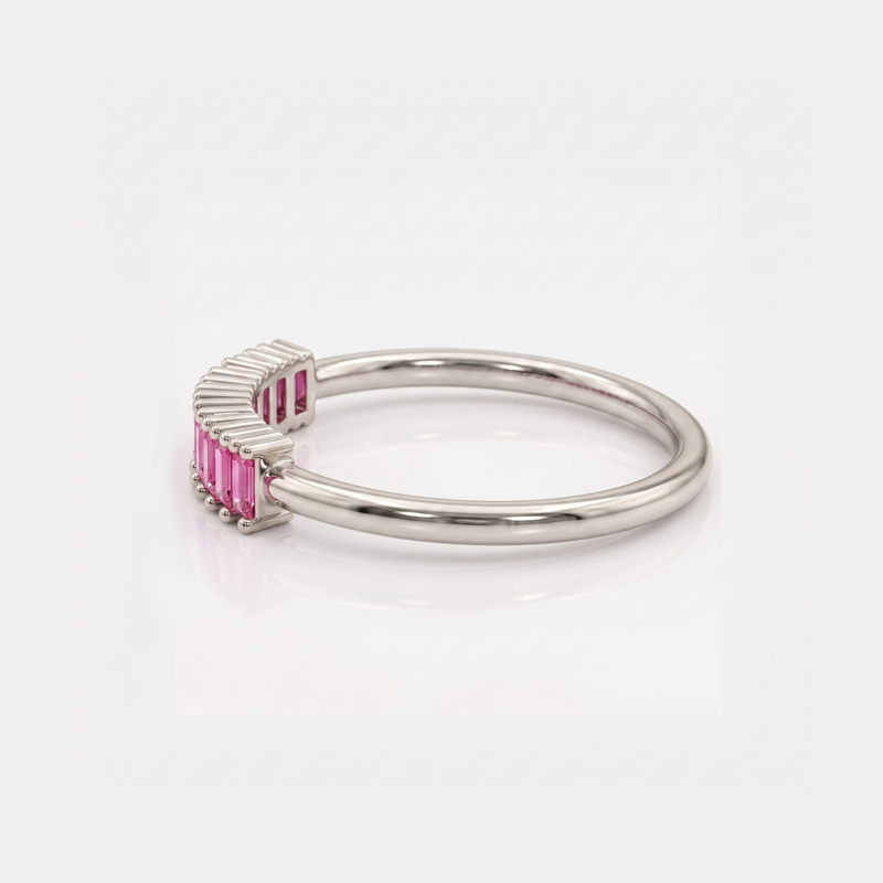 A silver ring featuring a curved, ribbed bezel setting with rectangular pink gemstones, shown on a clean white background.
