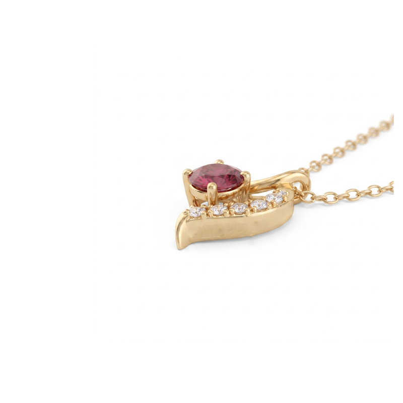 A gold pendant necklace featuring a curved wing-like design with a central oval pinkish-red gemstone and a row of small clear stones along the top curve, shown on a white background.