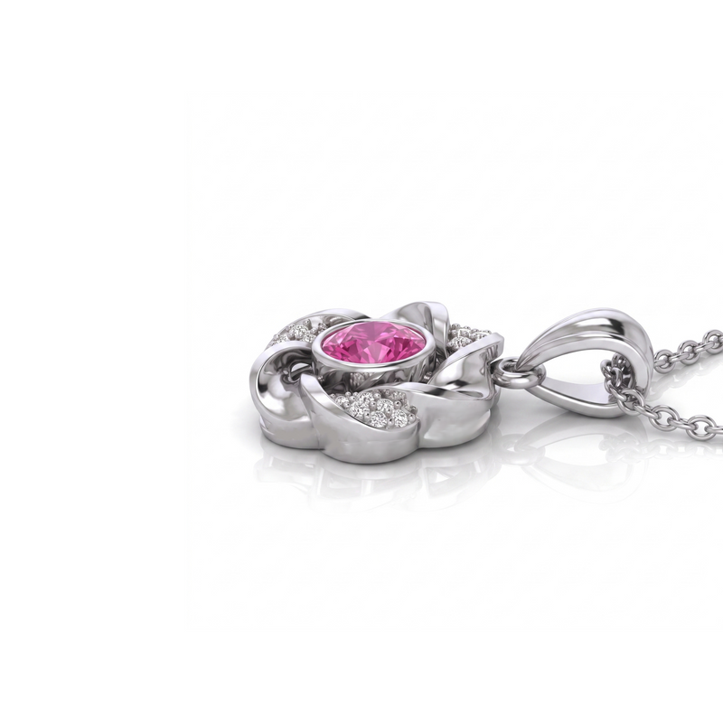 A silver-toned flower-shaped pendant necklace featuring a central round pink gemstone surrounded by small clear stones, shown on a white background with a faint reflection.