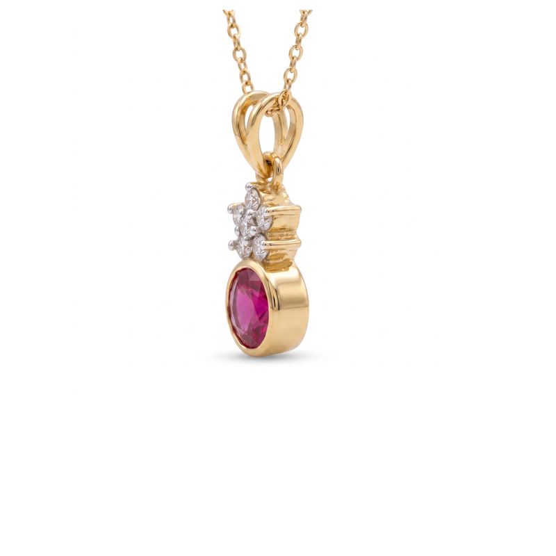 A yellow gold pendant necklace featuring a dangling oval pink gemstone and a small cluster of clear stones, shown on a plain white background.