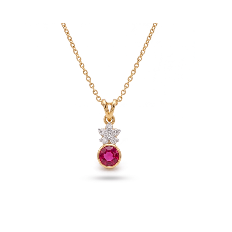A gold pendant necklace featuring a round pinkish-red ruby gemstone and a small cluster of clear cubic zirconia stones, displayed on a clean white background.