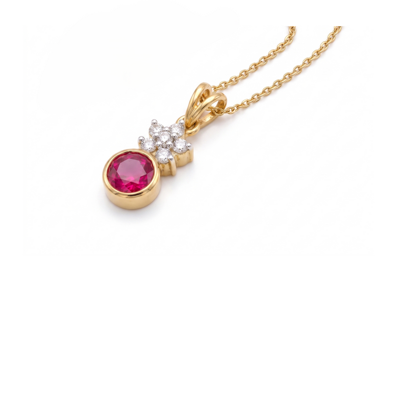 A yellow gold pendant necklace featuring a round pinkish-red ruby gemstone and a small cluster of clear stones above it, shown on a white background.
