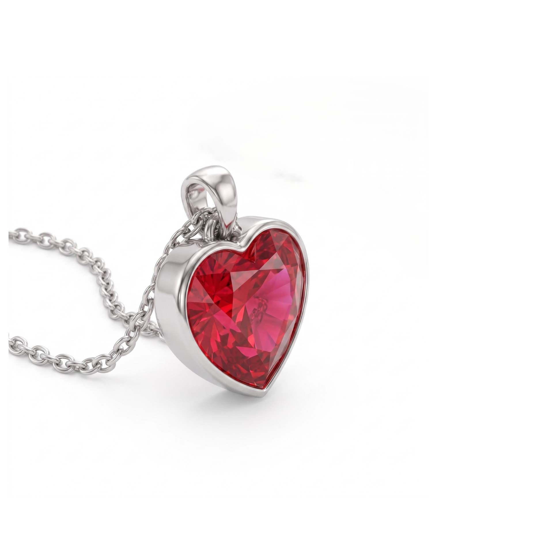 A heart-shaped red gemstone pendant in a silver bezel setting on a delicate silver chain, photographed on a clean white background.