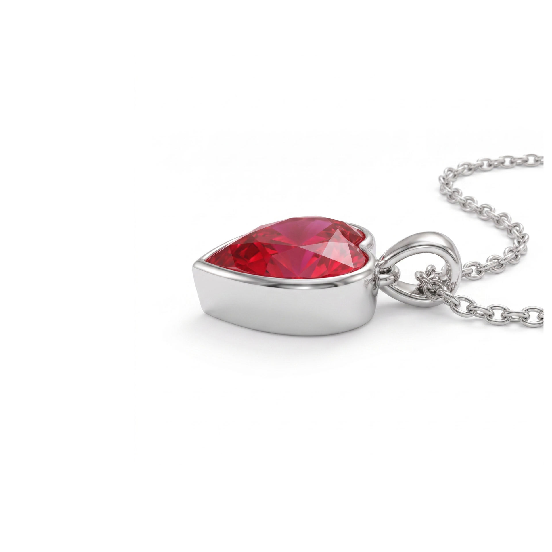 A silver heart-shaped pendant necklace featuring a faceted red gemstone, shown on a clean white background.