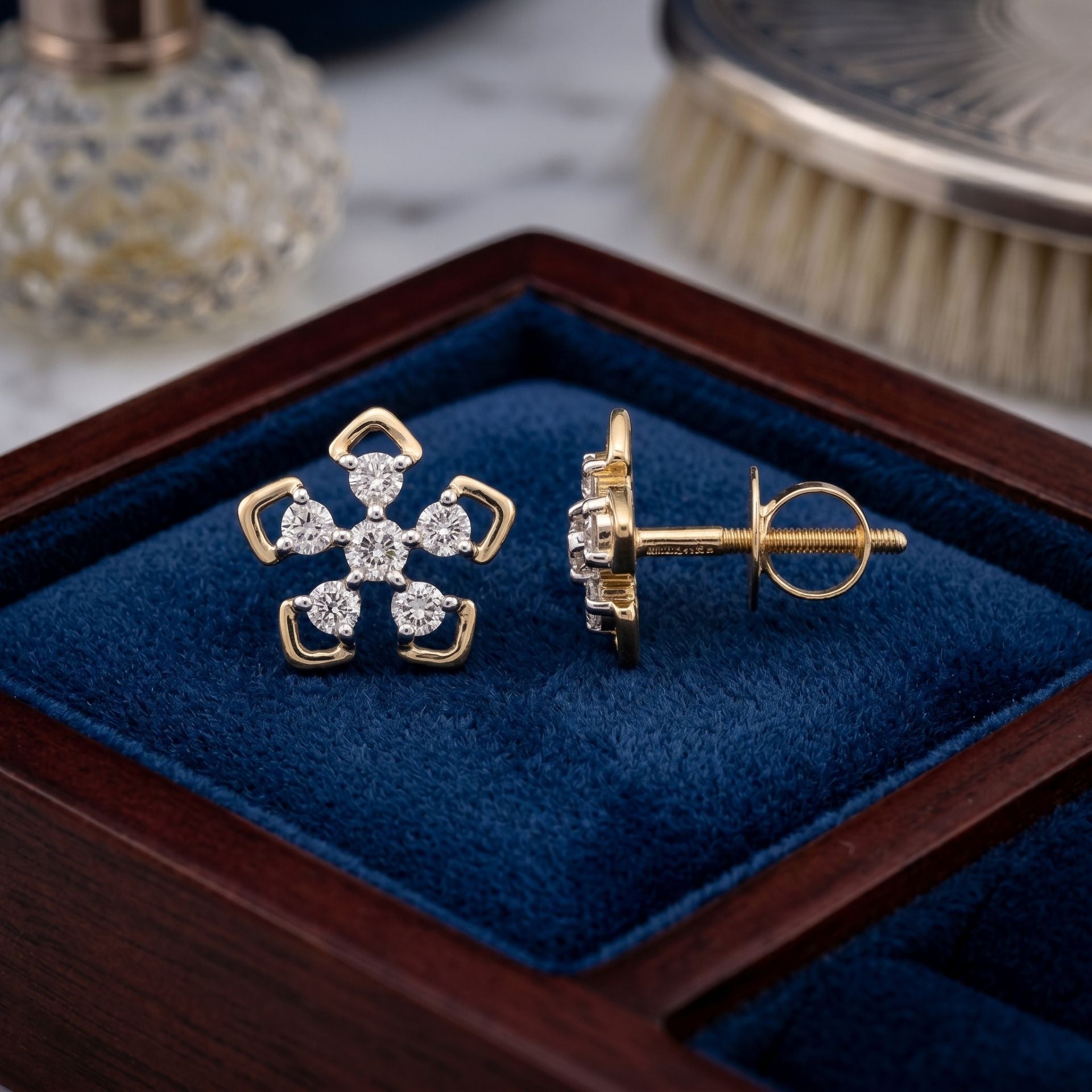 Floral lab grown diamond earrings displayed in a blue velvet jewellery box