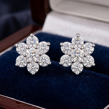 Floral lab grown diamond stud earrings on a dark blue velvet background