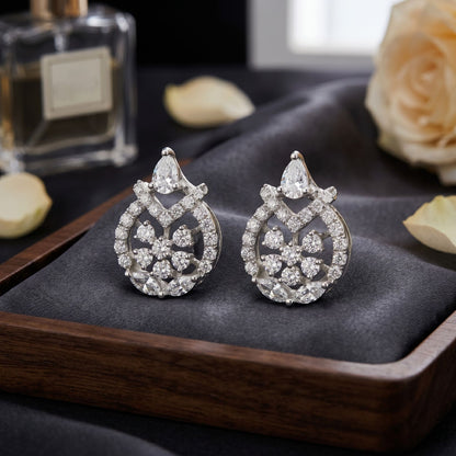 Lab grown diamond drop earrings displayed on a dark wooden surface