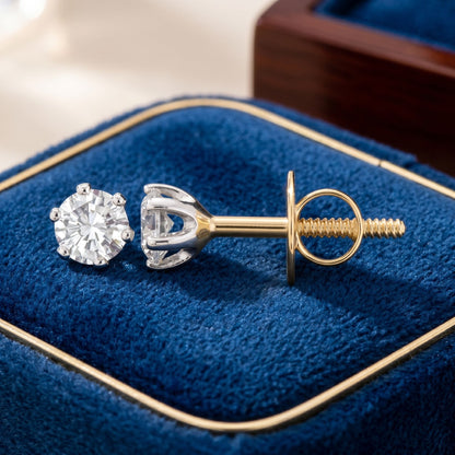 Gold lab-grown diamond stud earrings on a dark blue velvet background.