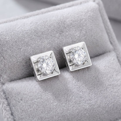 Square lab grown diamond stud earrings on a grey velvet cushion
