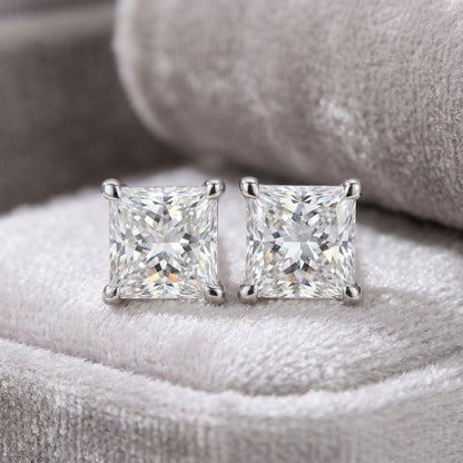 Square lab grown diamond stud earrings on a grey velvet cushion