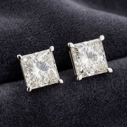 Princess cut lab grown diamond stud earrings on a black velvet background