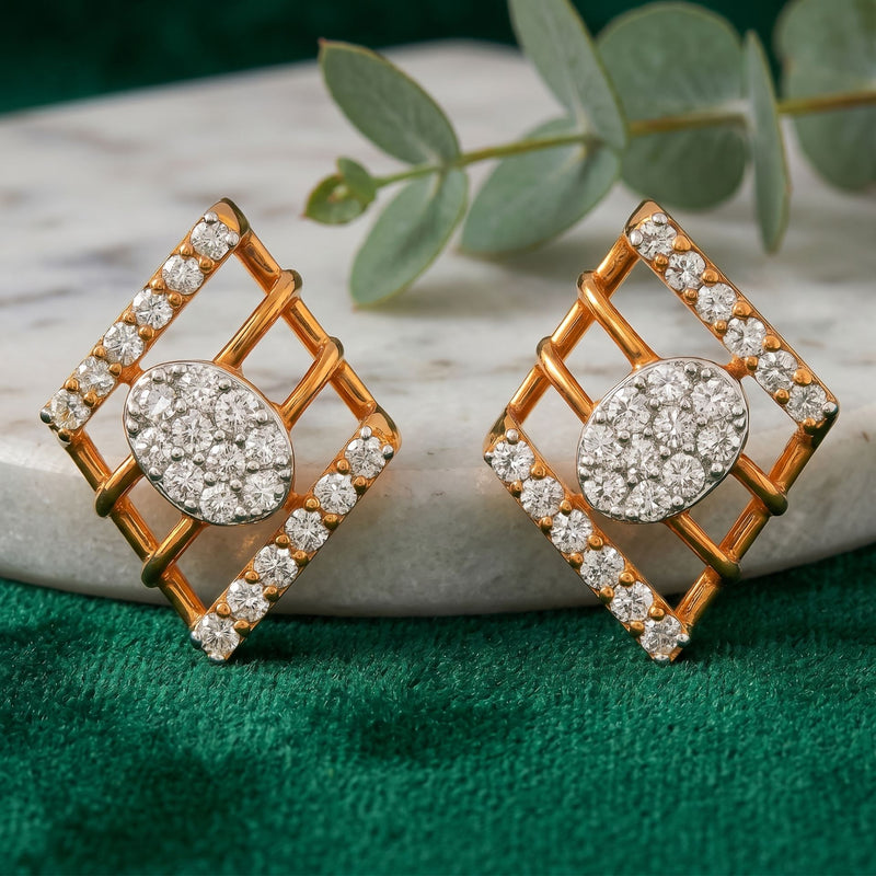 Geometric gold stud earrings featuring round clusters of sparkling lab-grown diamonds with diamond-accented square frames on a green velvet background.