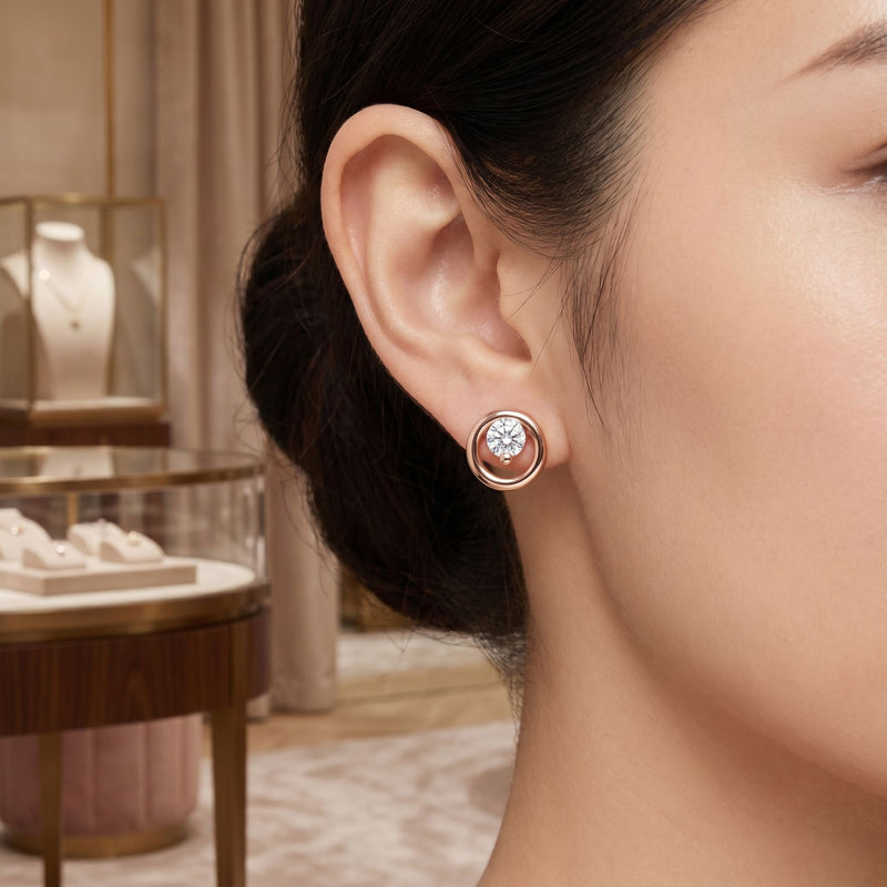 Close-up of a woman wearing rose gold earrings with a blurred jewelry store background