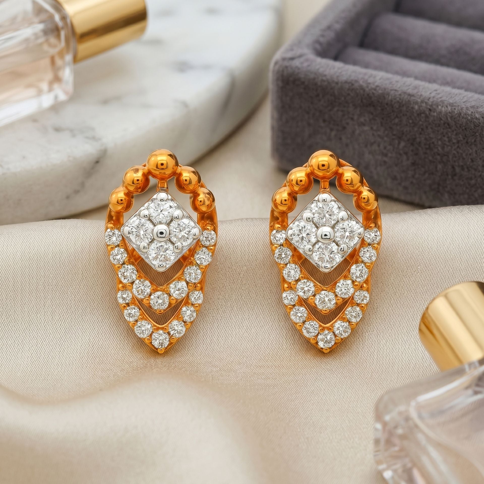 Rose gold geometric stud earrings featuring sparkling lab-grown diamonds on a soft neutral background.