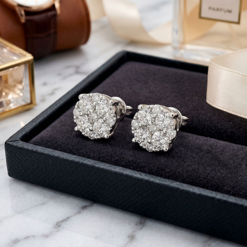 Pair of silver earrings on a black jewelry box with a marble surface background