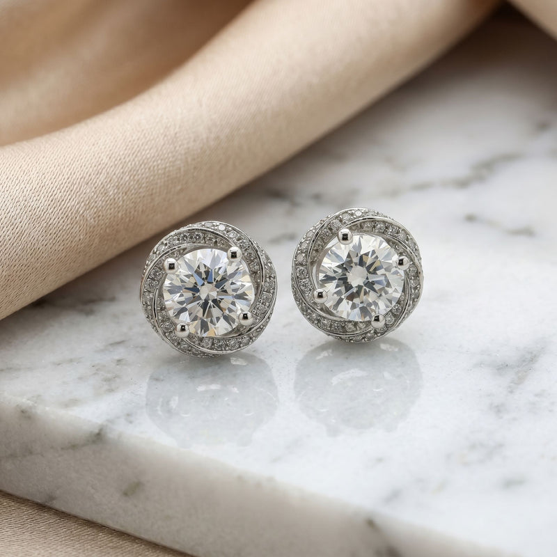Pair of diamond stud earrings on a marble surface