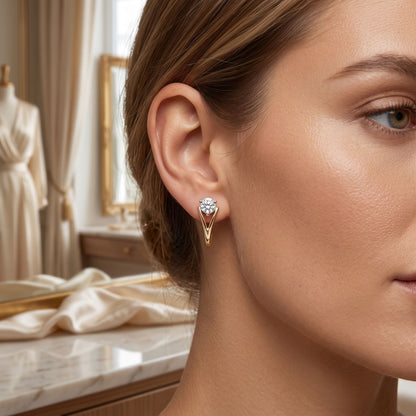Close-up of a woman wearing gold earrings with a blurred background