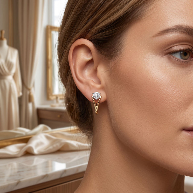 Close-up of a woman wearing gold earrings with a blurred background