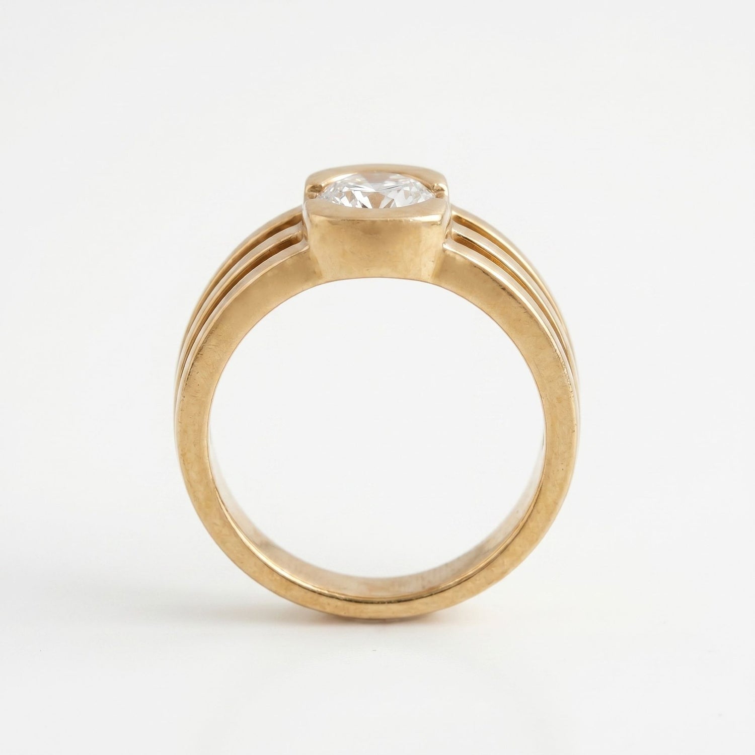 Gold ring with a diamond on a white background